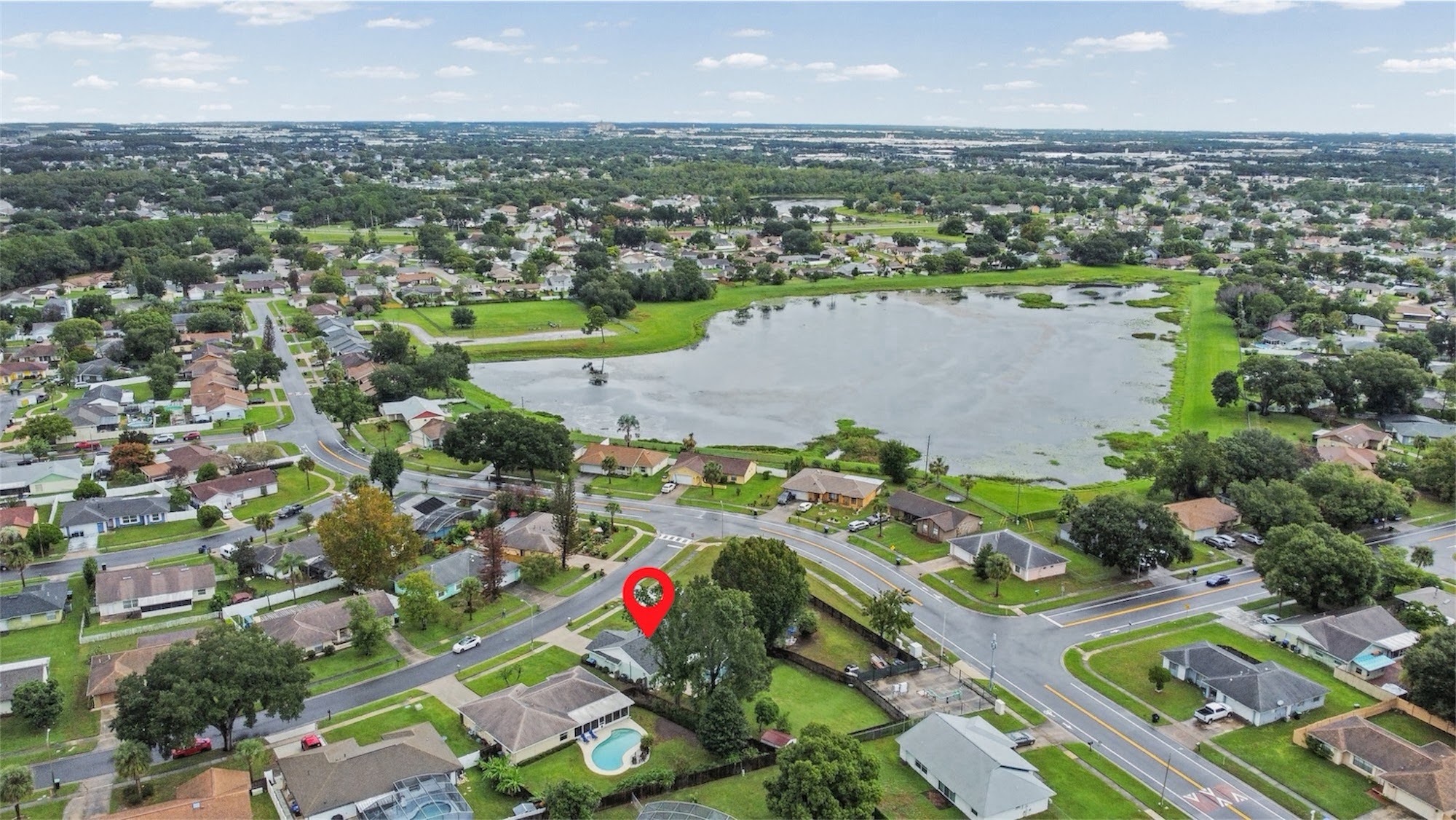 Aerial view of the home near a neighborhood lake