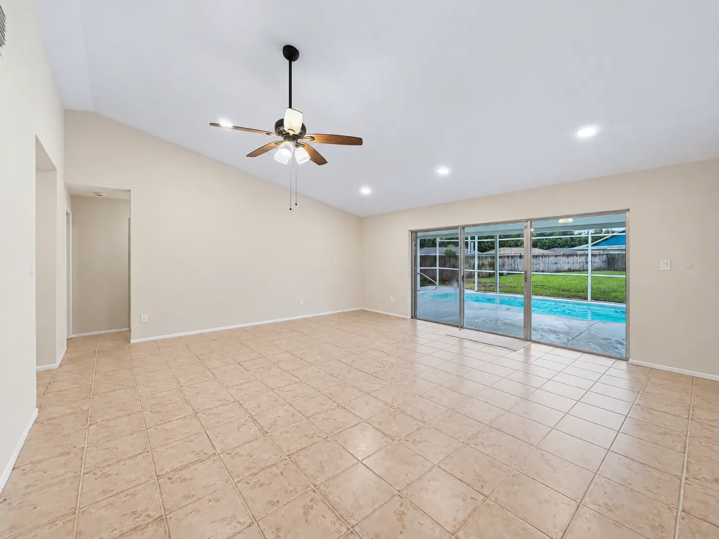 Bright living room with sliding glass doors to the pool